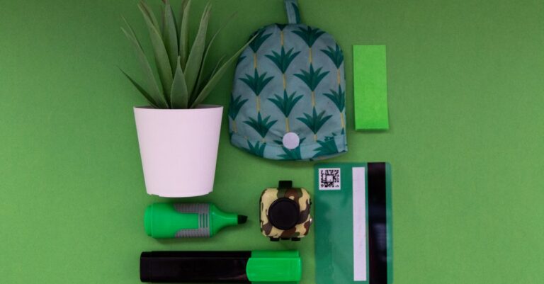 Vibrant green office supplies laid out on a green background, featuring potted plant and bank c - Ki - King Squishy