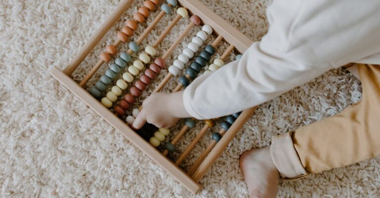 A young child interacts with a colorful wooden abacus, exploring learning through play. - King Squishy