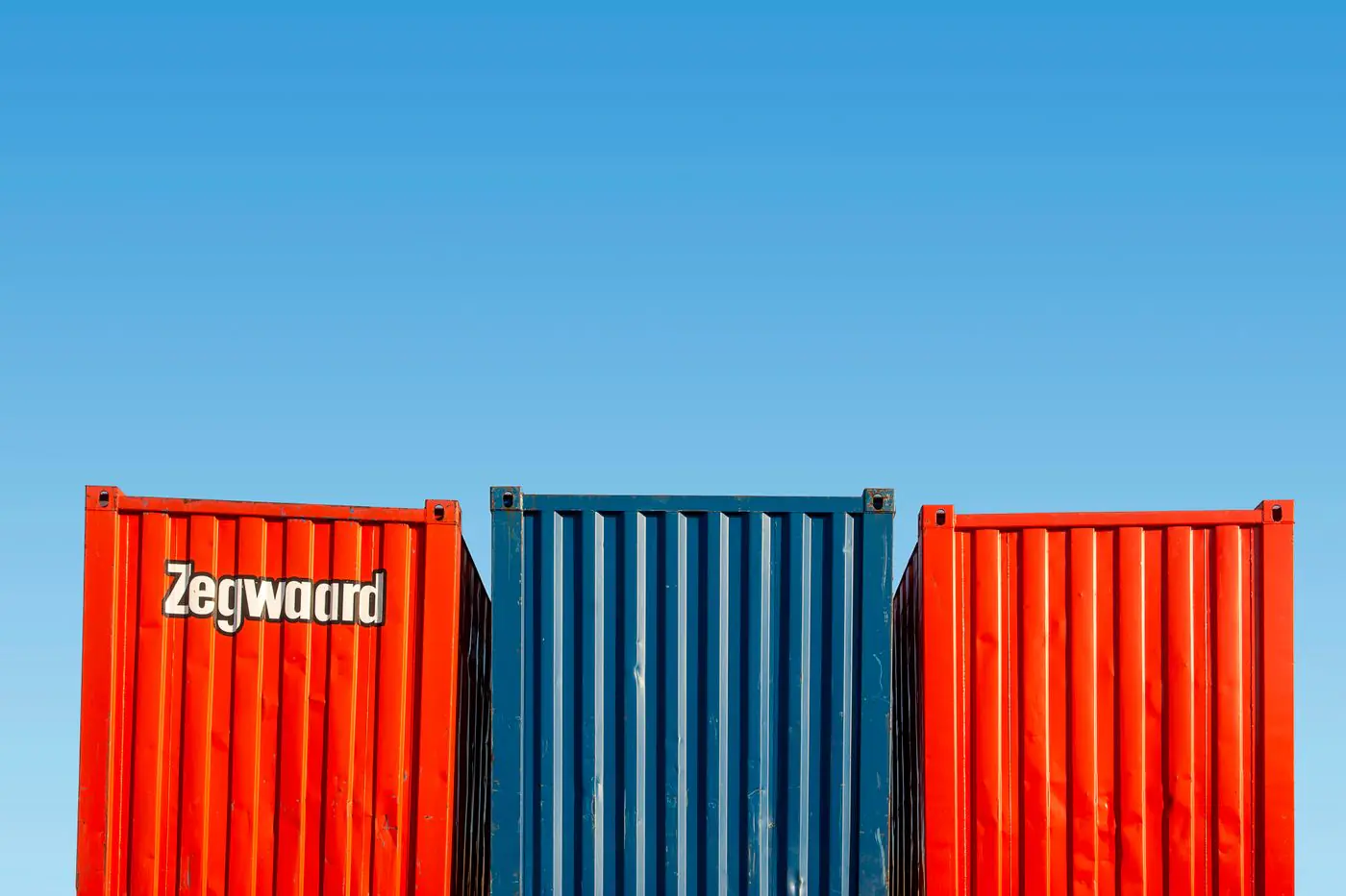 Colorful shipping containers under clear skies, perfect for logistic themes.