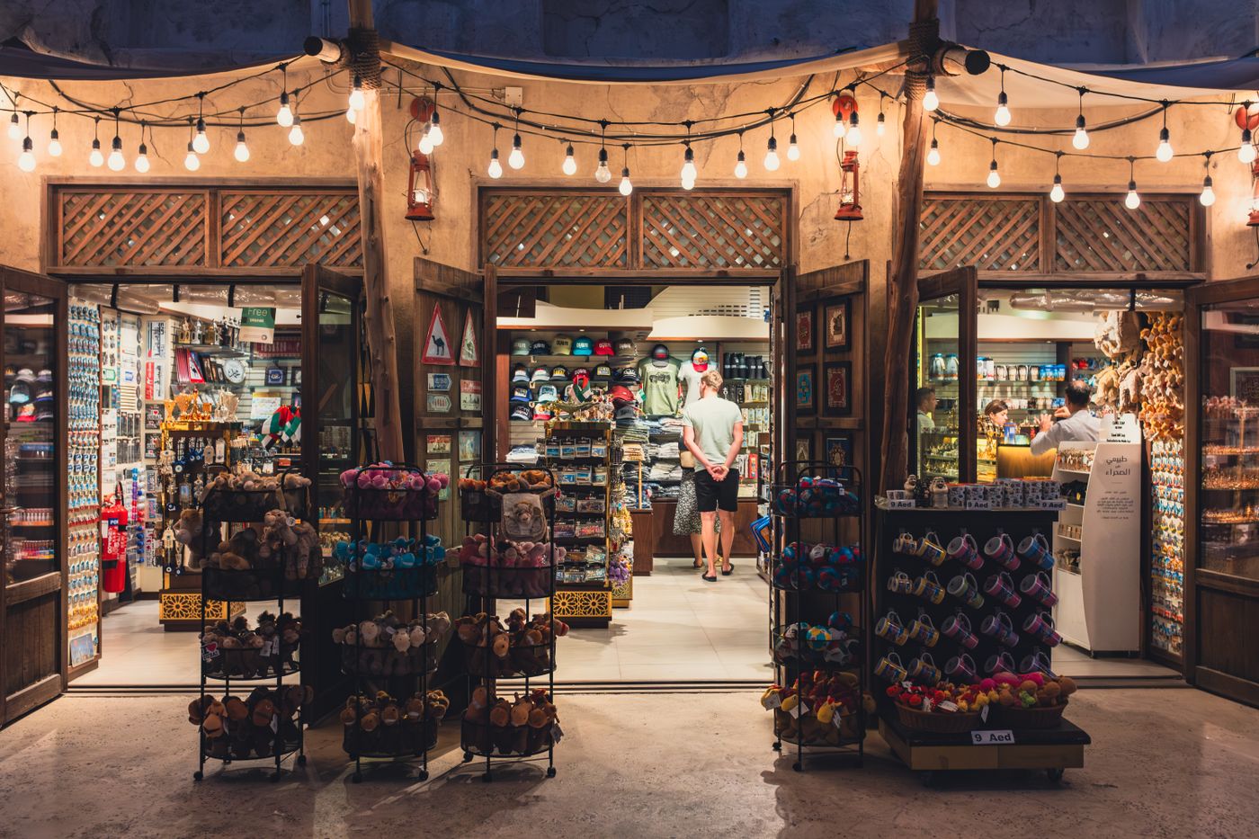 Illuminated souvenir shop in Dubai showcasing vibrant toys and gifts. A lively glimpse into local culture. - King Squishy