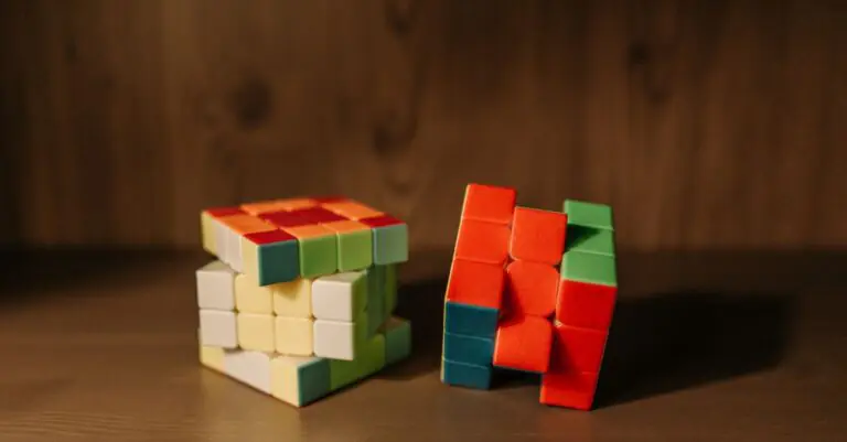 Two partially solved Rubik's cubes on a wooden surface, showcasing colorful patterns indoors. - King Squishy