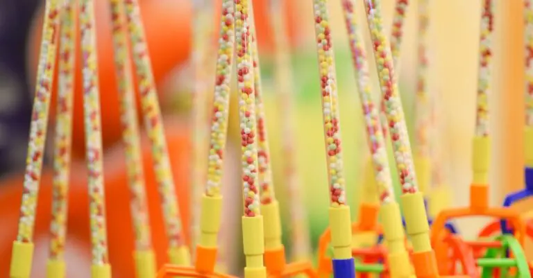 Close-up of vibrant beaded toy wands with colorful handles - King Squishy