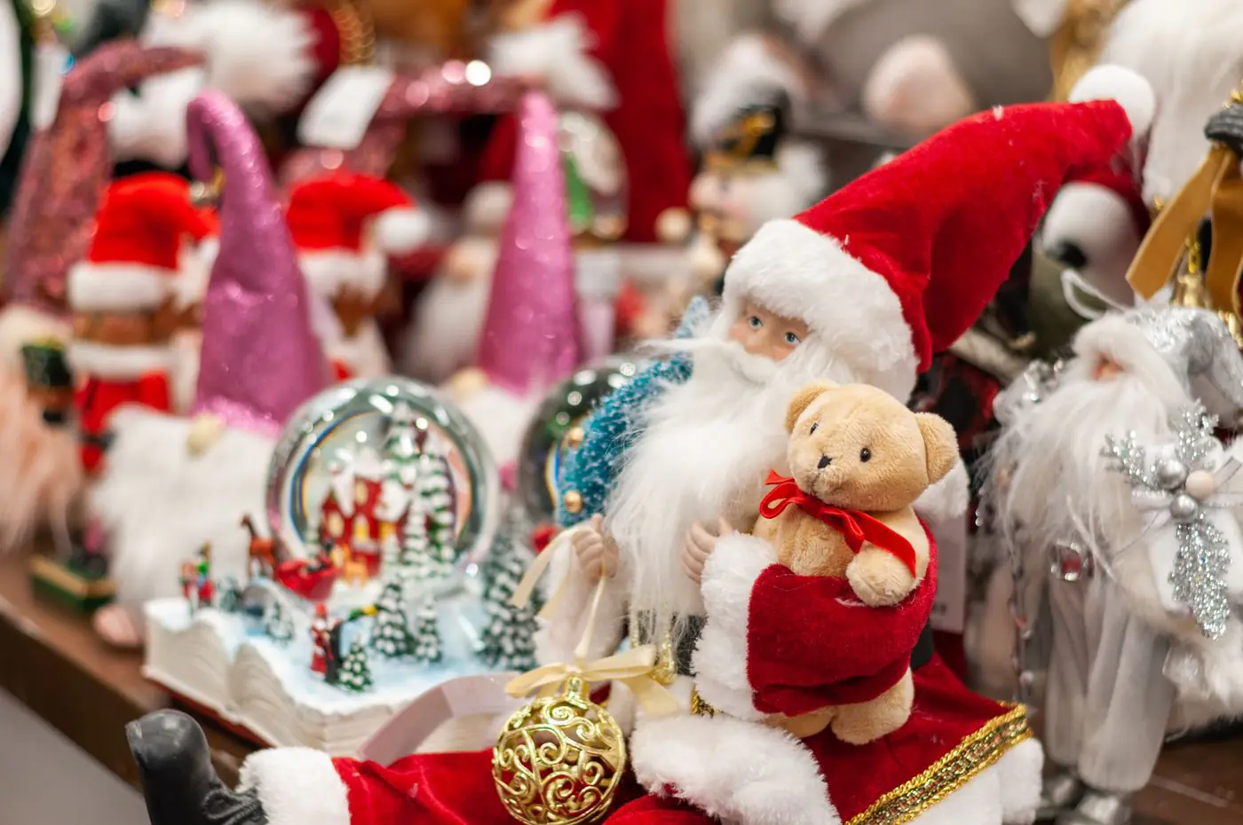 Close-up of colorful Christmas decorations featuring Santa and a teddy bear, ideal for holiday themes. - King Squishy