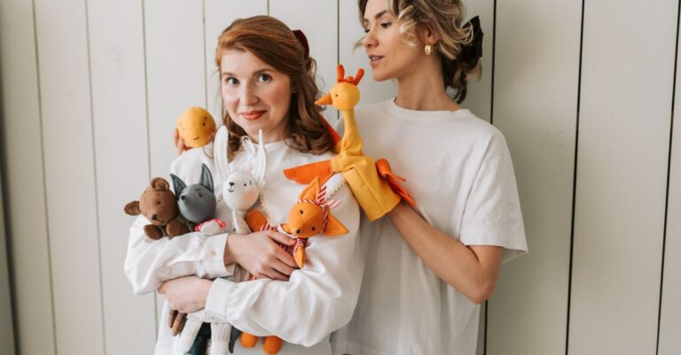 Two joyful women indoors holding assorted colorful plush toys, expressing playful and fun vibes - Ki - King Squishy