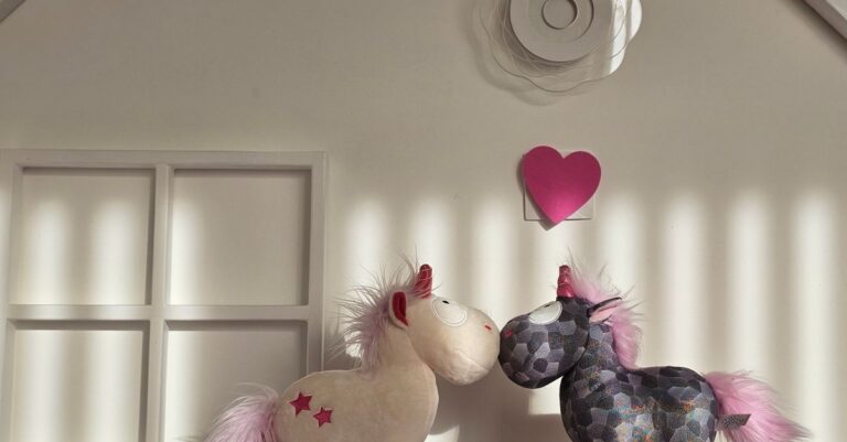 Adorable unicorn plush toys with pink manes on a bright, decorative shelf. - King Squishy - King Squishy