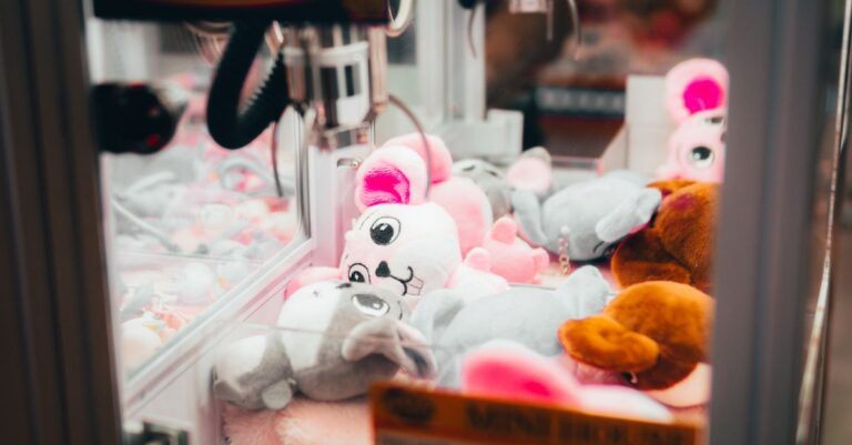 Close-up of a claw machine filled with colorful plush toys, evoking a playful and whimsical atm - Ki - King Squishy