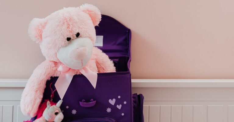 A pink teddy bear and unicorn plush toy in a purple backpack. Perfect for kids' room decor. - King S - King Squishy