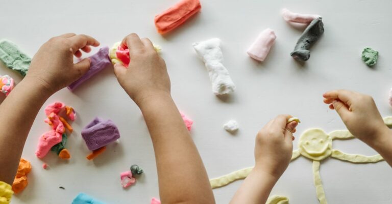 Children engaged in creative clay play, forming shapes and exploring colors on a white table. - King Squishy