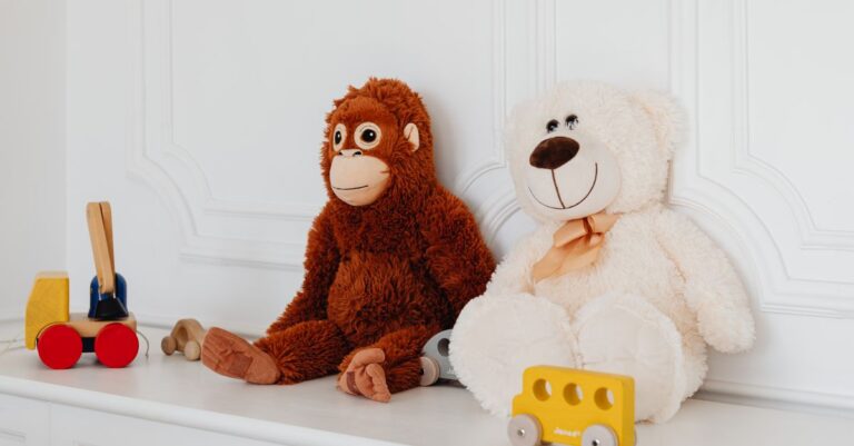 Cute plush teddy and monkey toys with wooden cars on a white shelf, perfect for kids' room deco - Ki - King Squishy