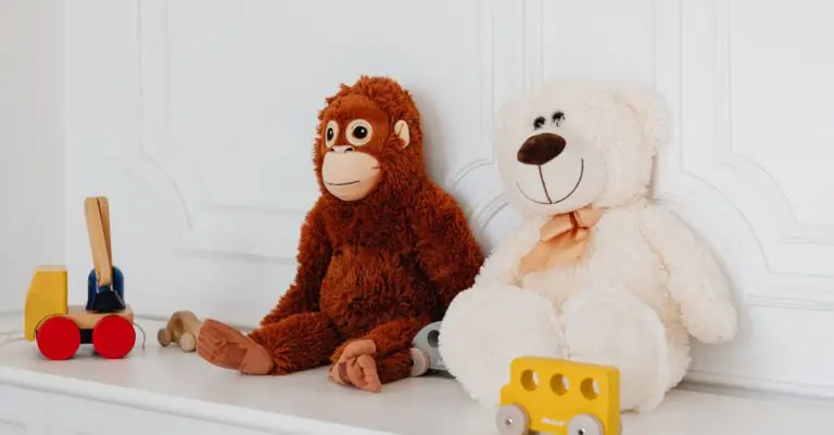 Cute plush teddy and monkey toys with wooden cars on a white shelf, perfect for kids' room deco - Ki - King Squishy