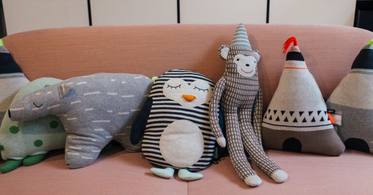 Collection of various soft toys placed in row on comfortable sofa in modern apartment - King Squishy - King Squishy