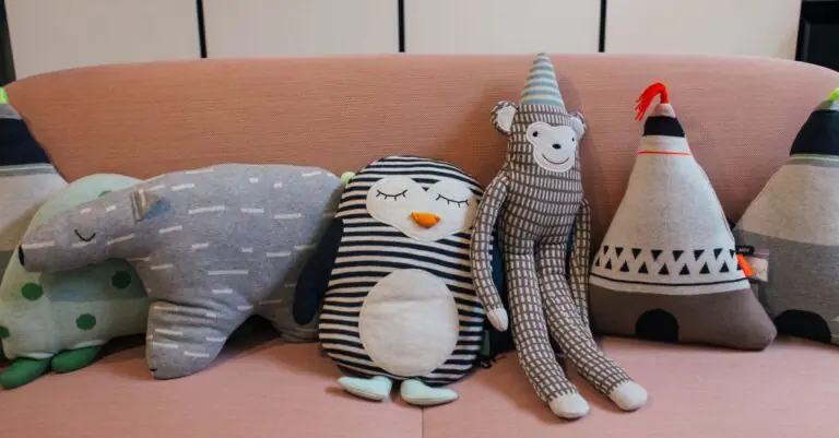 Collection of various soft toys placed in row on comfortable sofa in modern apartment - King Squishy - King Squishy