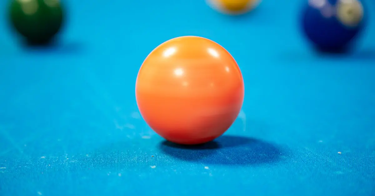 Close-up shot highlighting colorful billiard balls on a blue pool table. Perfect for leisure themes. - King Squishy
