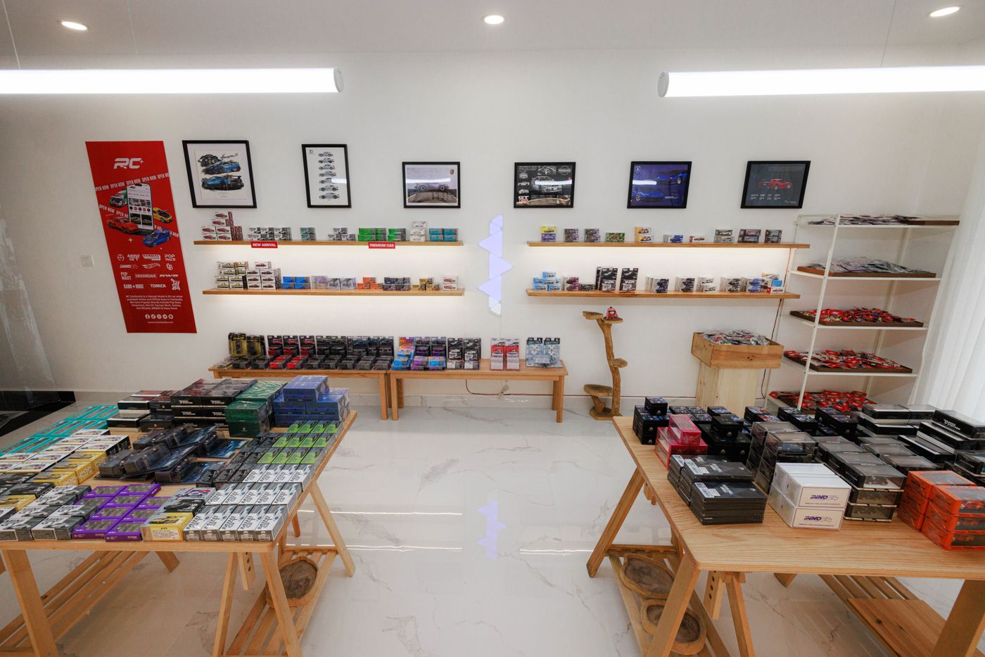 Interior of a diecast car model store in Phnom Penh showcasing wooden furniture and colorful model cars. - King Squishy