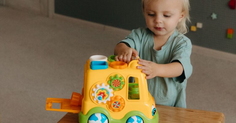 Adorable toddler engaged with a vibrant educational toy, promoting fun learning indoors. - King Squishy