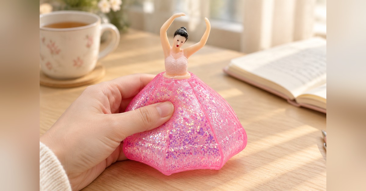 Squishy de bailarina com recuperação lenta sendo apertado na mão, demonstrando estímulo tátil calmante para baixo astral - King Squishy atacado